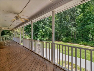 Wooden terrace featuring ceiling fan and a yard