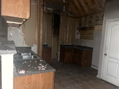 Kitchen with dark tile patterned flooring, lofted 
