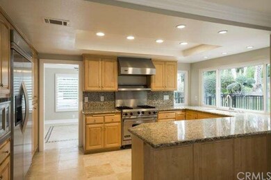 Kitchen with granite counters, travertine flooring