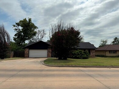 View of front facade with a garage and a front lawn