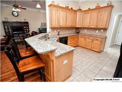 Kitchen features granite, a bar peninsula