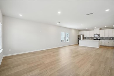 Unfurnished living room featuring light wood-style