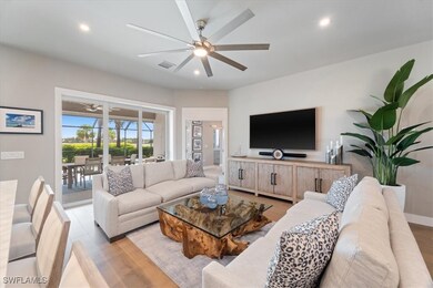 Living area with ceiling fan, light wood-style flo