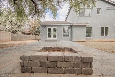 Back of house featuring stucco siding, french door