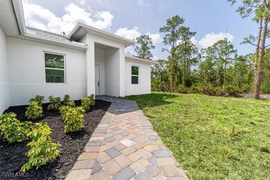 Entrance to property featuring stucco siding and a