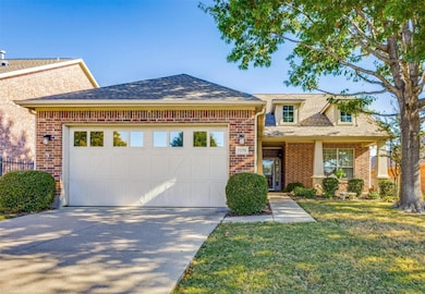 Well landscaped front yard with mature oak tree