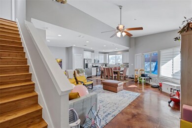 Living room featuring stairs, ceiling fan, recess