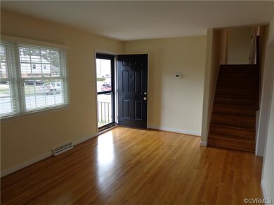 Spacious living room with double windows and oak f
