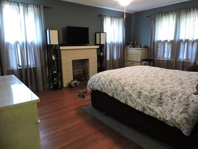 Master Bedroom with natural light and gas fireplac
