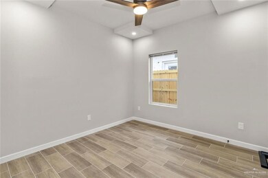 Unfurnished room with baseboards, a ceiling fan, light wood-type flooring, and recessed lighting