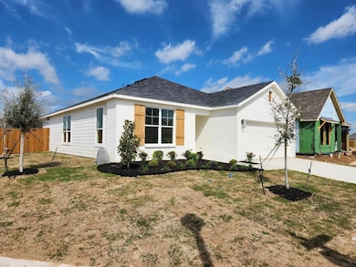 Ranch-style home with a front lawn and a garage