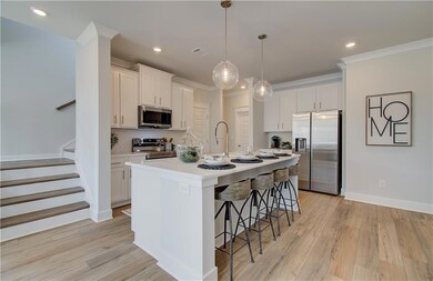 Kitchen with white cabinetry, a center island with