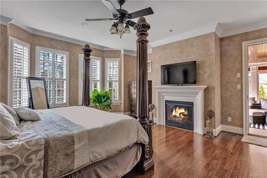 First floor master with gas fireplace, hardwood floors, crown moulding and ceiling fan with a light. Door to porch.