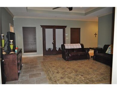 Living Room. DOUBLE FRENCH DOORS LEAD OUT TO COVER