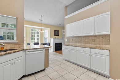 Kitchen with decorative backsplash, hanging light 
