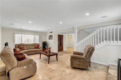 Living room featuring stairs, crown molding, reces