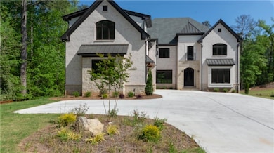 French country style house with a standing seam ro