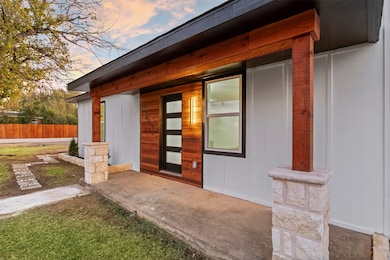 Doorway to property featuring covered porch