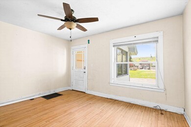 Unfurnished room with baseboards, light wood finished floors, and ceiling fan