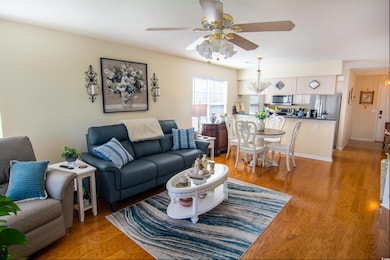 Living area with a ceiling fan, baseboards, light 