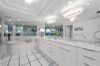 Bathroom with a notable chandelier, shower with se