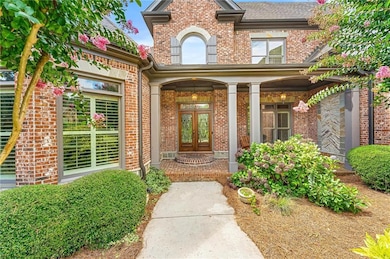 Entrance to property featuring french doors, brick