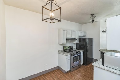 Kitchen with stainless steel electric range oven,