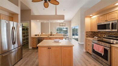 Kitchen with large walk-in pantry and maple wood cablinets