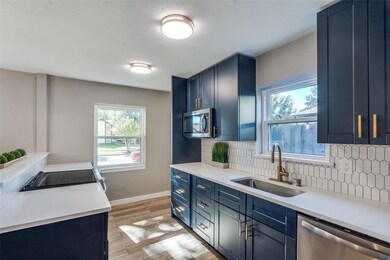 Kitchen with decorative backsplash, blue cabinets,