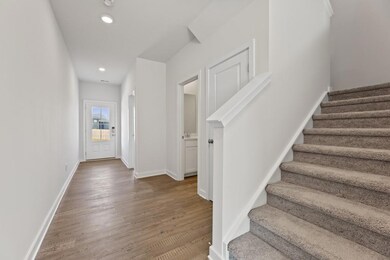 Stairs featuring wood finished floors, recessed li