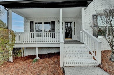 Doorway to property with a porch and brick siding