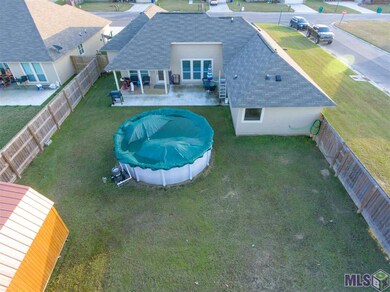 Back of home with Above Ground Pool and Shed