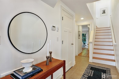 Tiled entry, and hardwood steps.