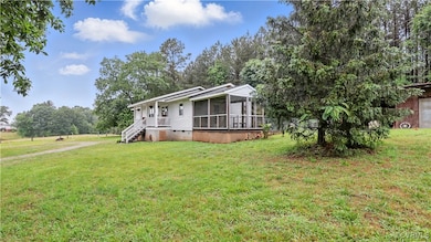 View of front of property featuring a sunroom, cra