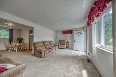 Spacious living room with picture window and coat