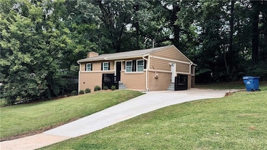 side of home with view of the driveway
