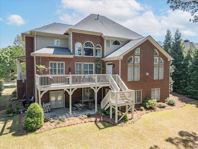 Rear view of house with brick siding, a lawn, and 