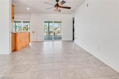 Unfurnished room with ceiling fan and light tile flooring