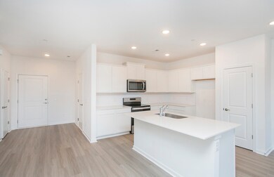 ***Photo from another townhouse recently completed in community with same finishes***

The Kitchen Island is the perfect space for quick meals and provides additional prep space for cooking.