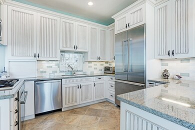 The custom kitchen features beadboard cabinetry an
