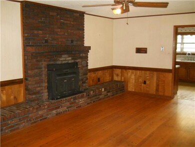 Huge Den with Wood burning insert fireplace. Wide 