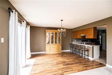 The open dining area features beautiful flooring, 