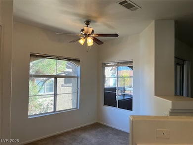 Unfurnished room featuring carpet and a ceiling fan