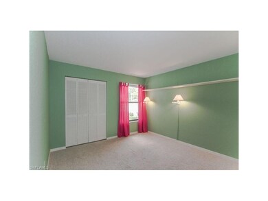 Spacious guest bedroom with a pool view