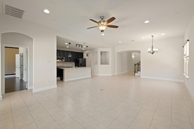 Unfurnished living room featuring arched walkways