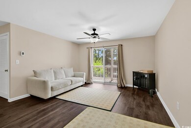 Living room with wood finished floors and ceiling fan