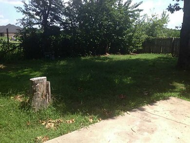 Exterior Back. Fence, shrubbery and mature trees a