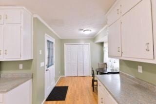 Kitchen featuring light countertops, crown molding