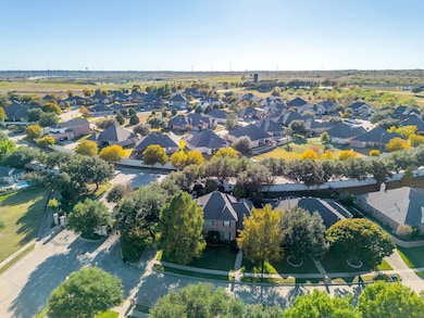 Aerial view of property's location with nearby suburban area