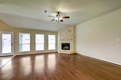 Bright and open living room with tons of natural light and floor to ceiling stone chimney *Pictures are from an identical home in the same neighborhood*